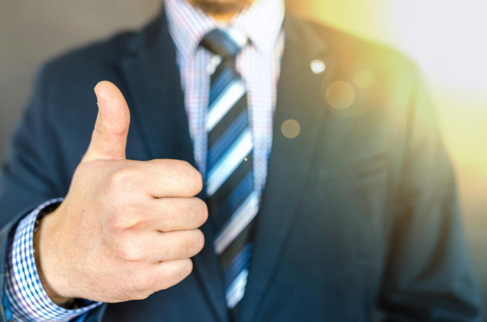 man in suit thumbs up